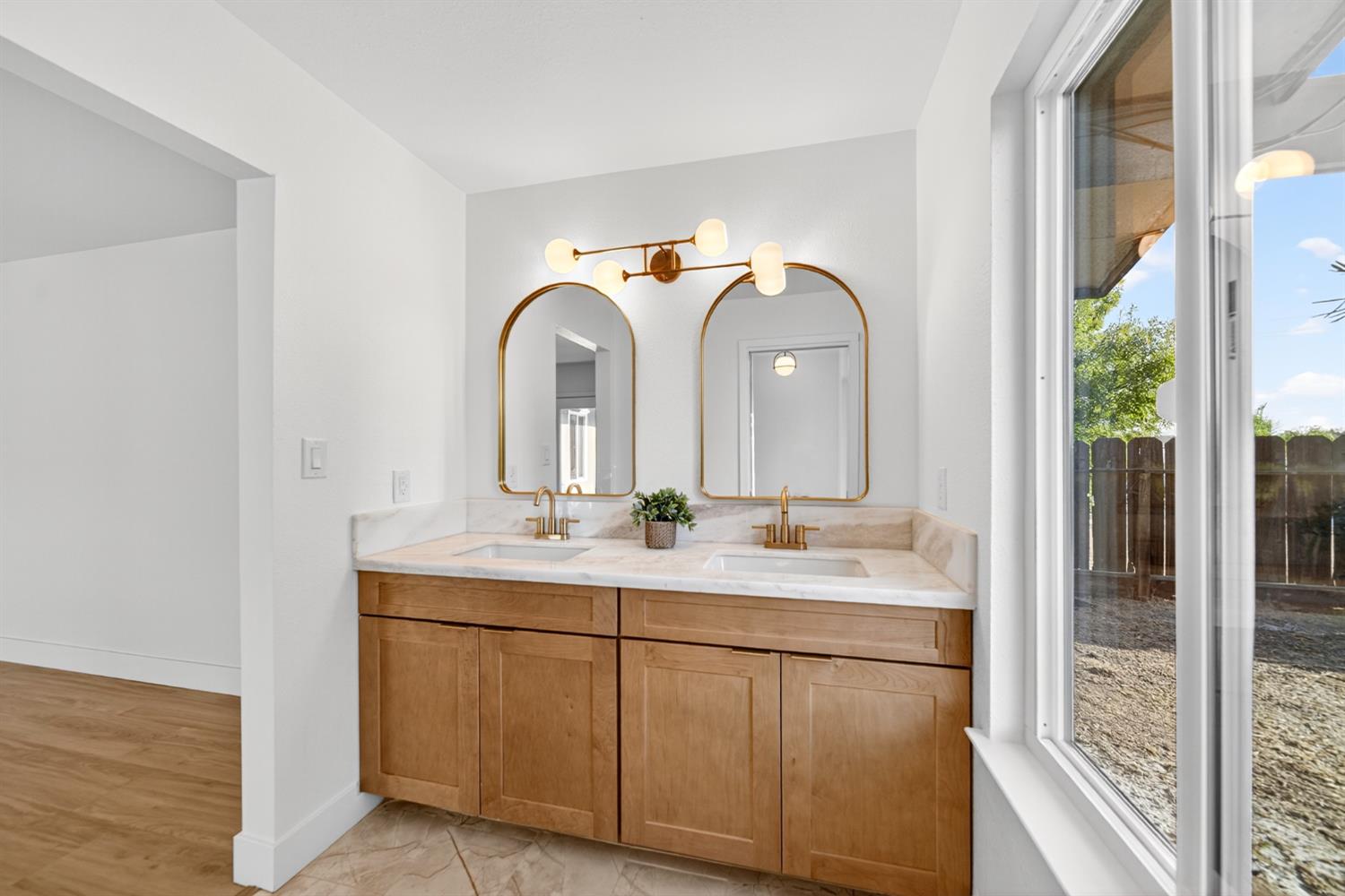 18578 Farallon Road Madera, CA 93638 - Photo 24 of 29 a en suite bathroom with a double vanity sink and a mirror