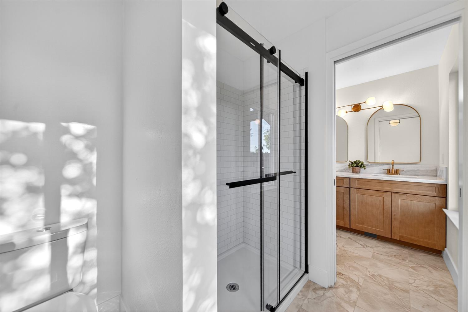 18578 Farallon Road Madera, CA 93638 - Photo 25 of 29 a bathroom with a double vanity sink mirror and shower