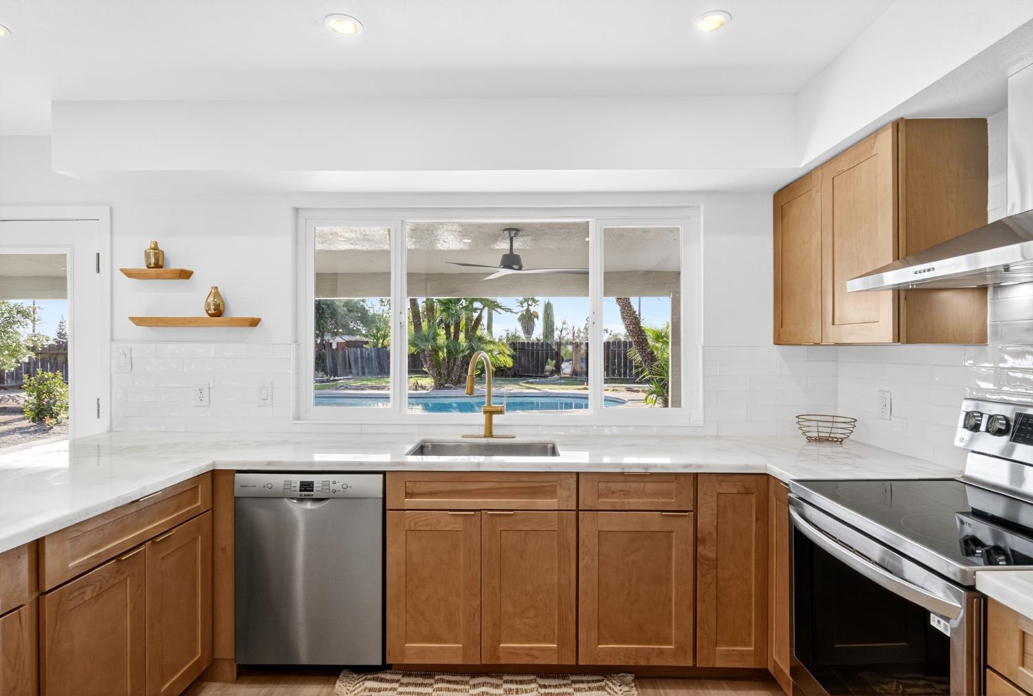 18578 Farallon Road Madera, CA 93638 - Photo 7 of 29 a kitchen with stainless steel appliances granite countertop a sink a stove and a microwave