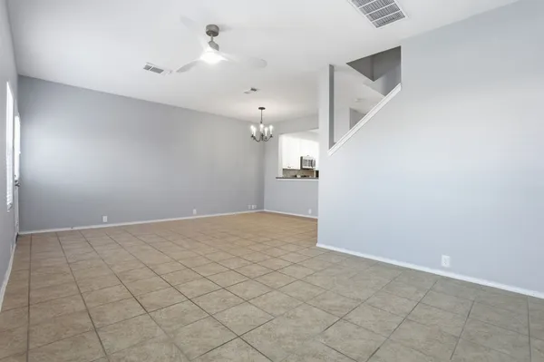 a kitchen with a refrigerator and a stove top oven