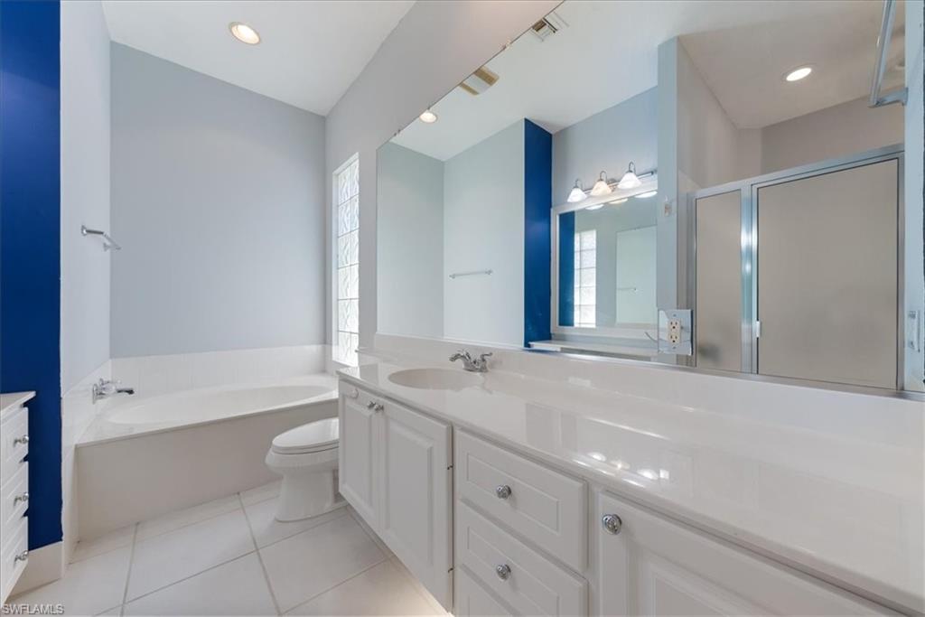 3060 Ellice Way Naples, FL 34119 - Photo 15 of 31 Bathroom with plenty of natural light, tile patterned floors, and vanity