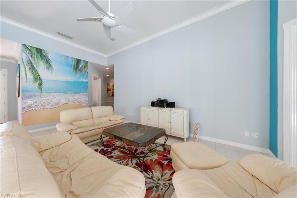 3060 Ellice Way Naples, FL 34119 - Photo 5 of 31 Living room featuring visible vents, tile patterned flooring, and ornamental molding