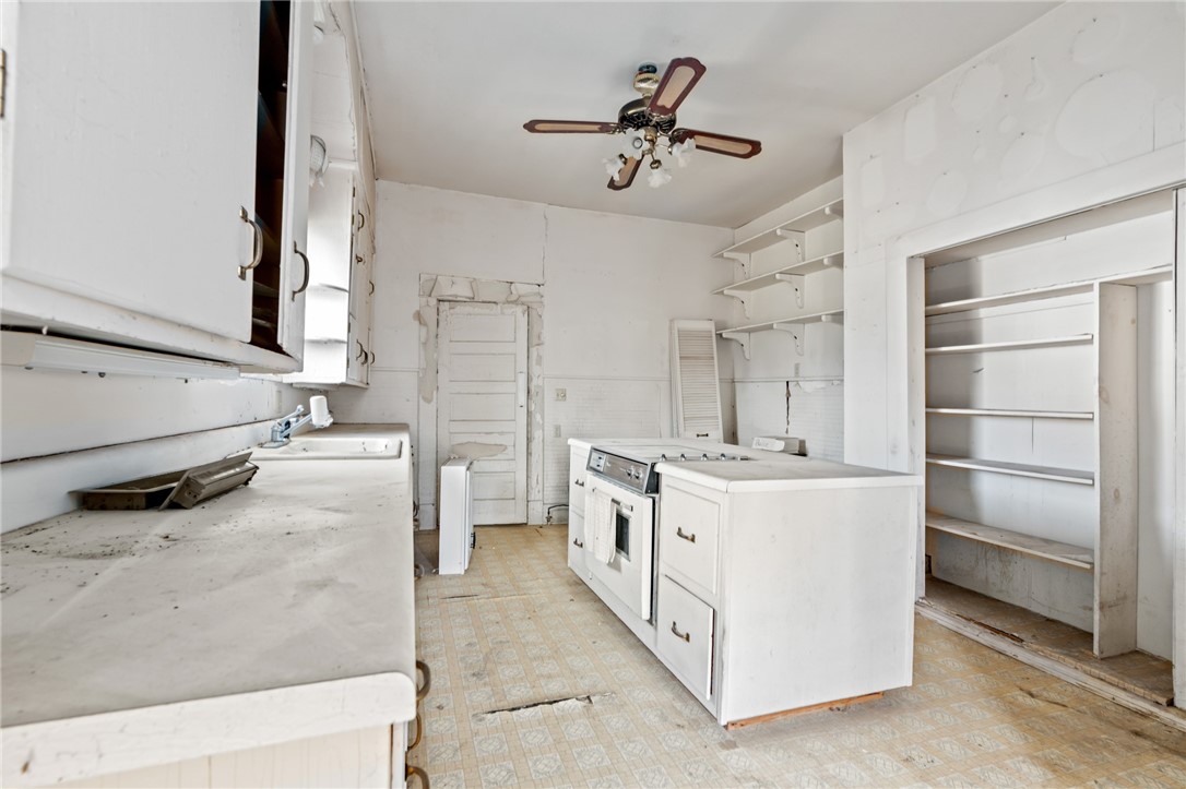 306 East Adams Street Itasca, TX 76055 - Photo 13 of 29 a kitchen with a stove and a refrigerator