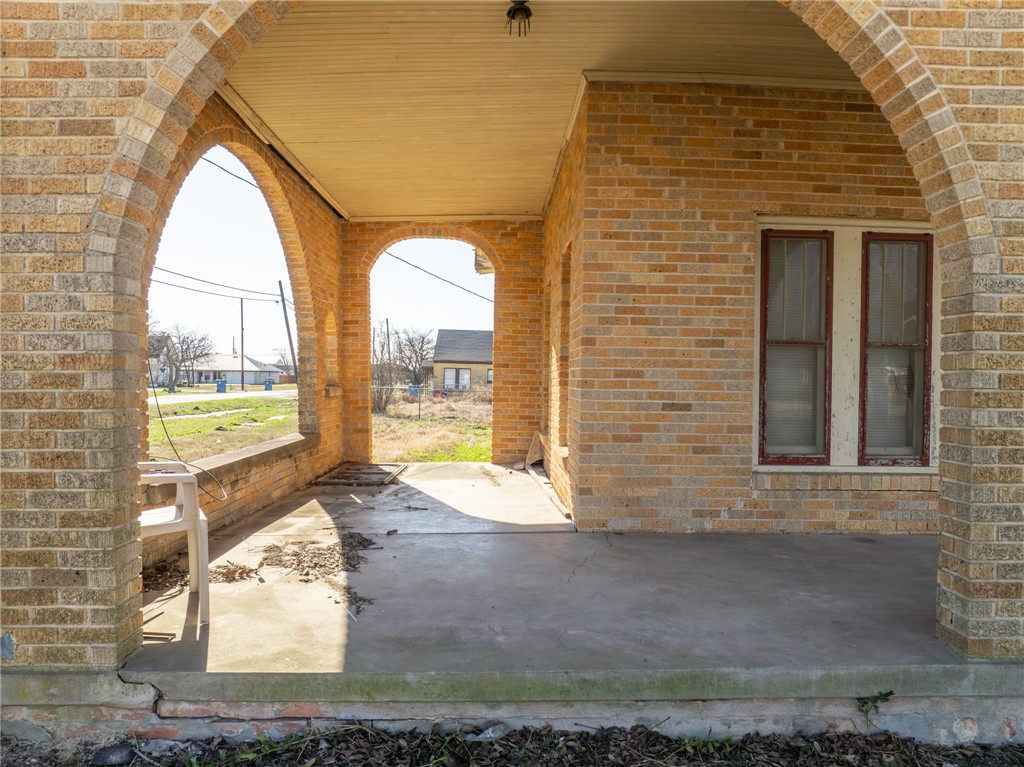 306 East Adams Street Itasca, TX 76055 - Photo 2 of 29 a view of a house with a backyard