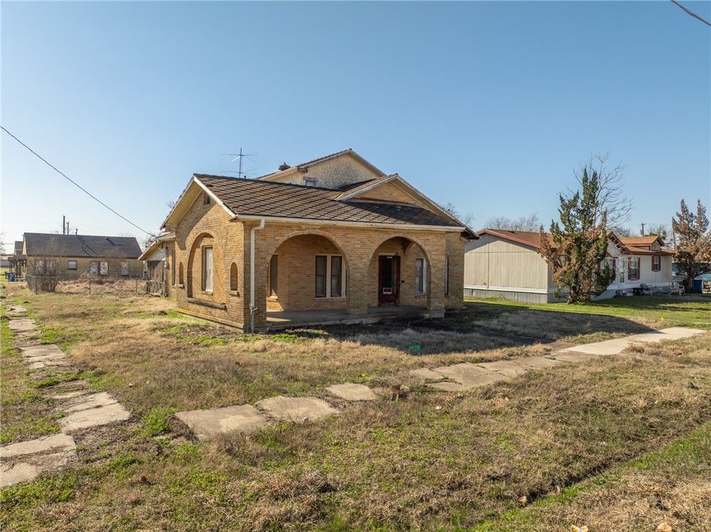 306 East Adams Street Itasca, TX 76055 - Photo 24 of 29 a front view of a house with a yard