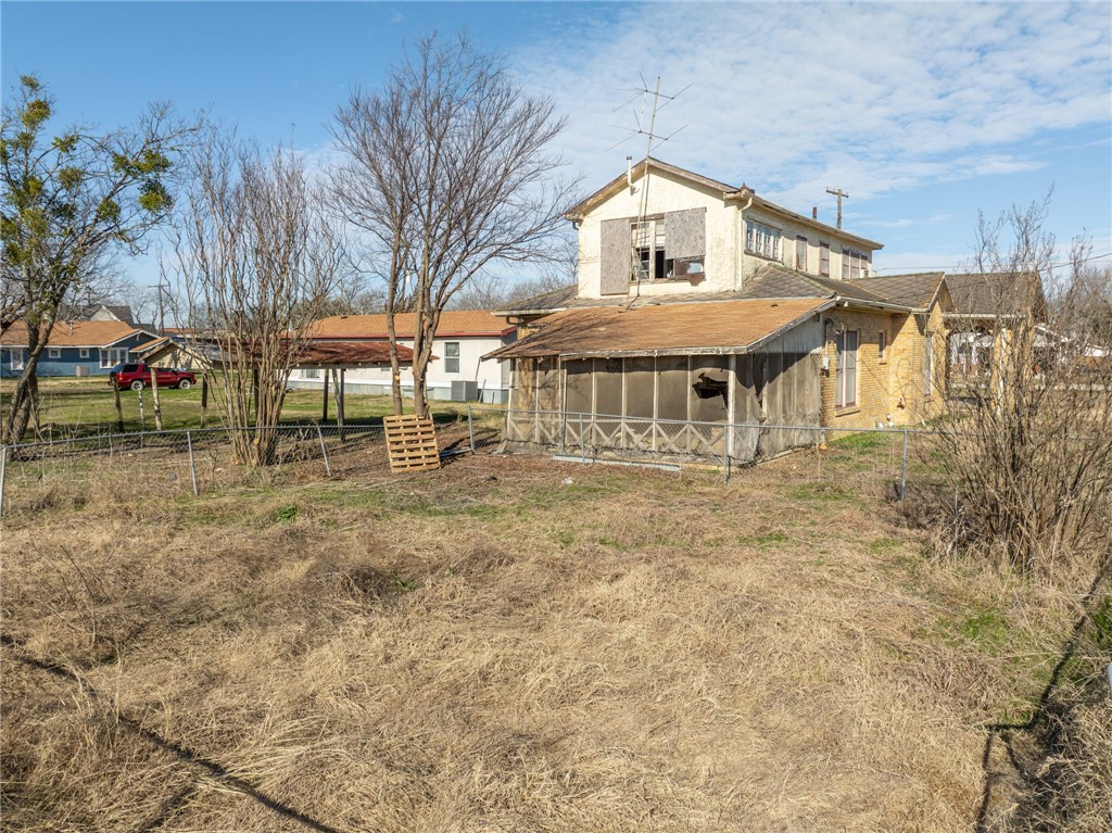 306 East Adams Street Itasca, TX 76055 - Photo 26 of 29 a front view of a house with a yard
