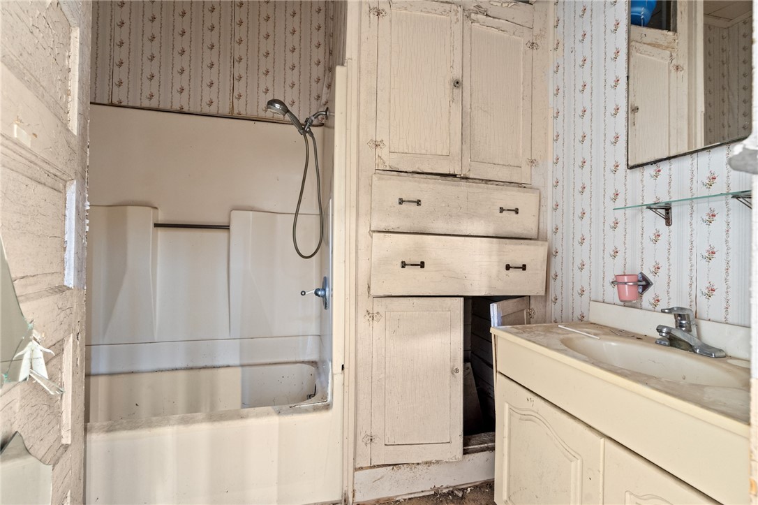 306 East Adams Street Itasca, TX 76055 - Photo 8 of 29 a bathroom with a shower and a sink
