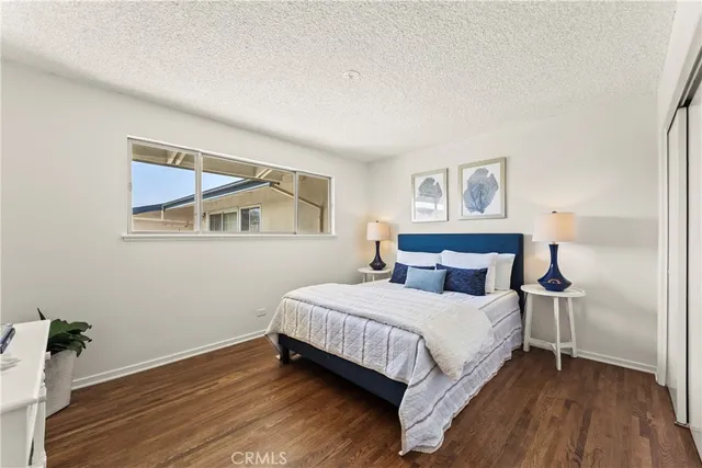 a bedroom with a bed and a painting on the wall