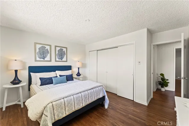 a bedroom with a bed and a painting