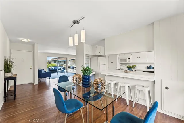 a view of a dining room with furniture wooden floor and a chandelier