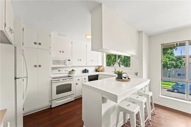 a kitchen with stainless steel appliances a stove a sink and a refrigerator