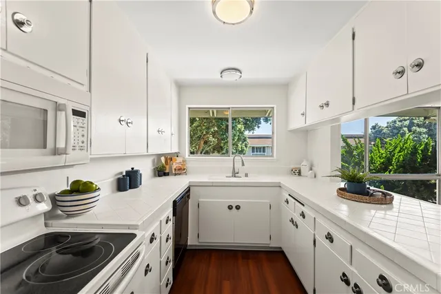 a kitchen with a sink stove and cabinets