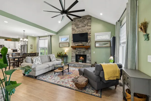 a living room with furniture a flat screen tv and a fireplace