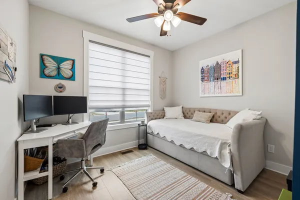 a bedroom with a bed and a desk