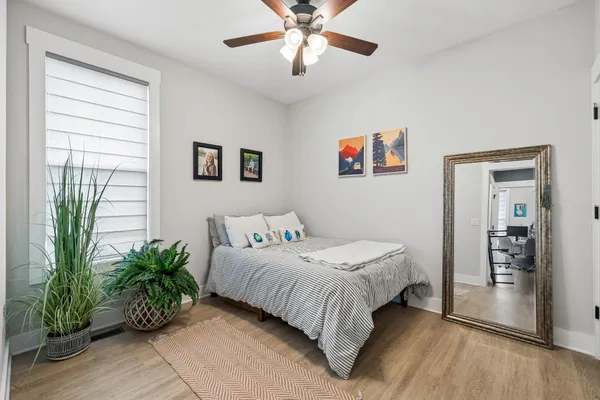 a bedroom with a bed and a potted plant