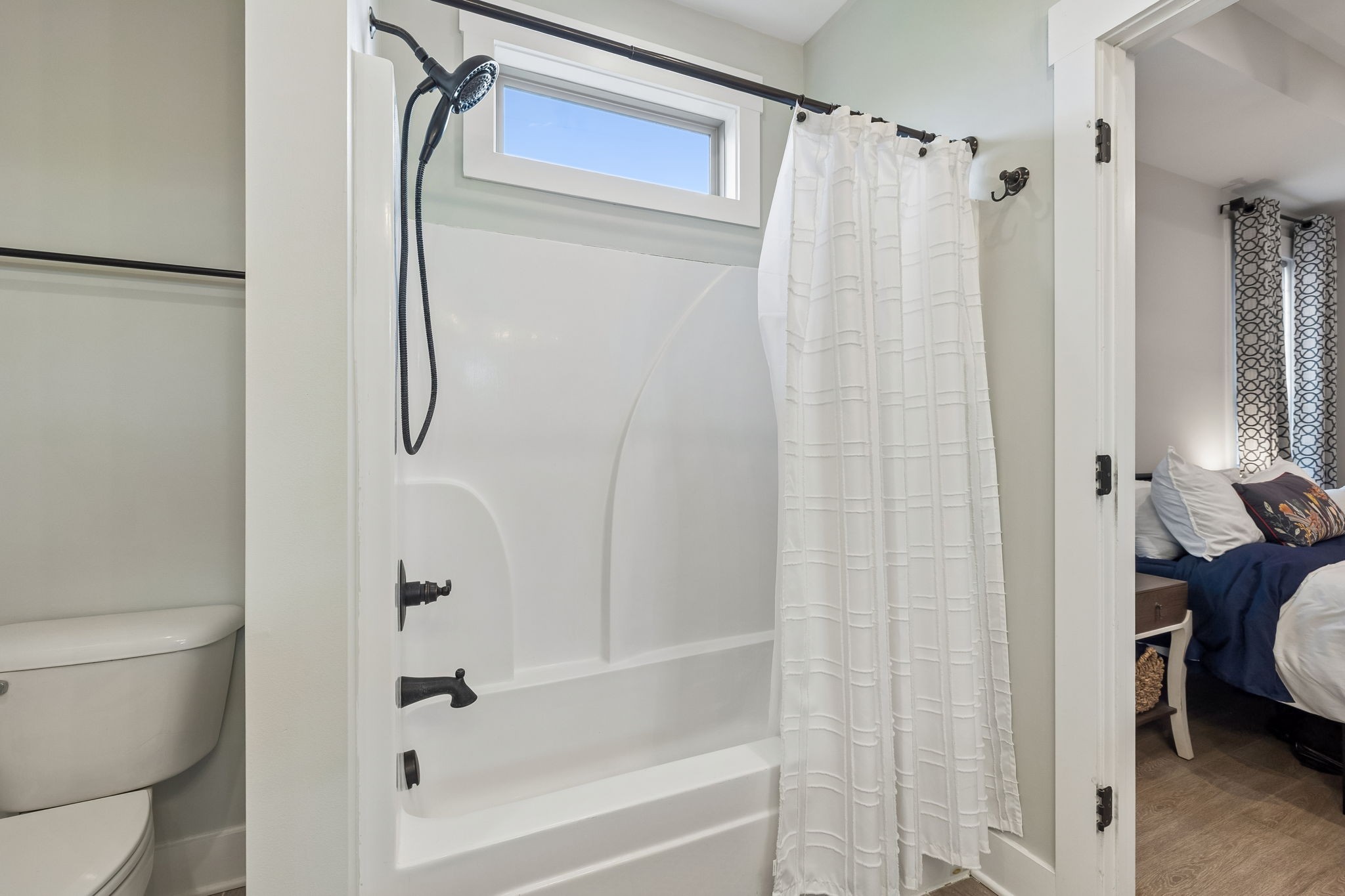 126 Julia Ann Court Springfield, TN 37172 - Photo 24 of 37 a bathroom with a shower curtain and a toilet