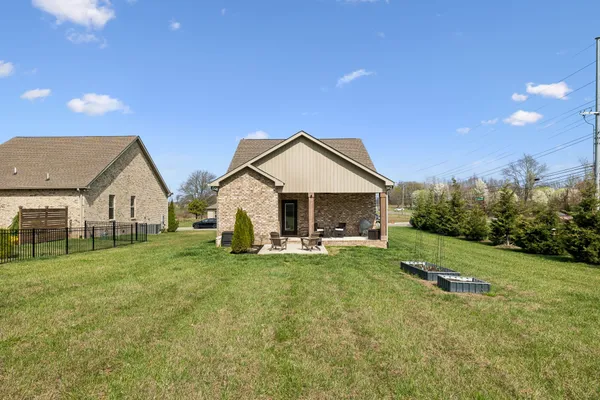 a view of a house with yard and sitting area