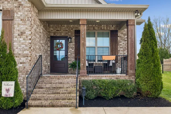 a front view of a house with outdoor seating