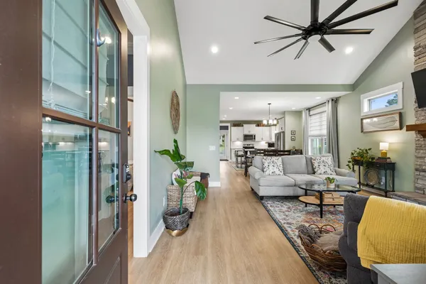 a living room with furniture and a chandelier