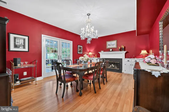 a view of a dining room with furniture a chandelier and wooden floor