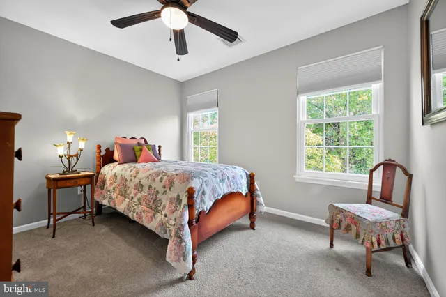 a bedroom with a bed chair and window