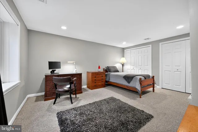 a bedroom with a bed and a desk