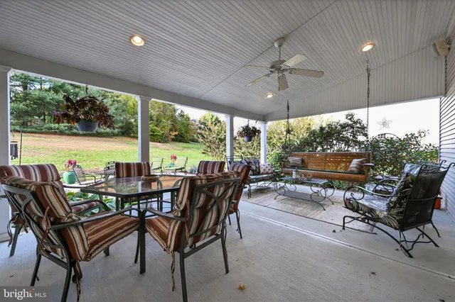 a view of a patio with chairs and floor to ceiling window