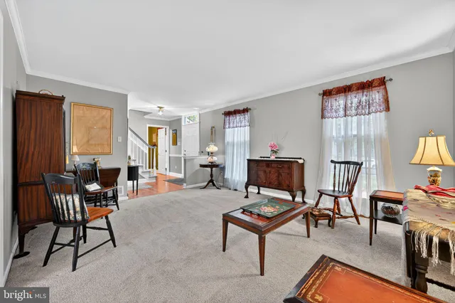 a living room with furniture a piano and a window