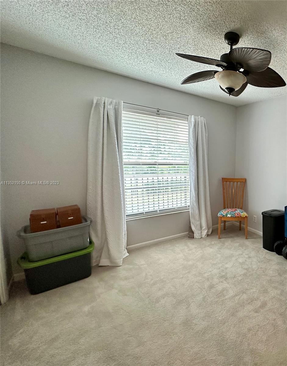 250 Gate Road, Unit 258 Hollywood, FL 33024 - Photo 12 of 30 a living room with furniture and a ceiling fan