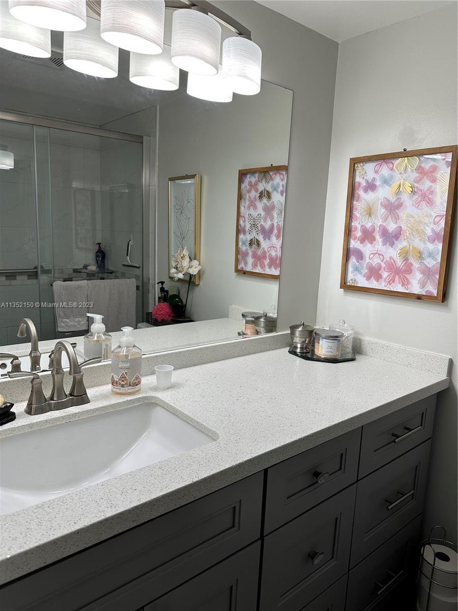 250 Gate Road, Unit 258 Hollywood, FL 33024 - Photo 16 of 30 a bathroom with a sink and a mirror