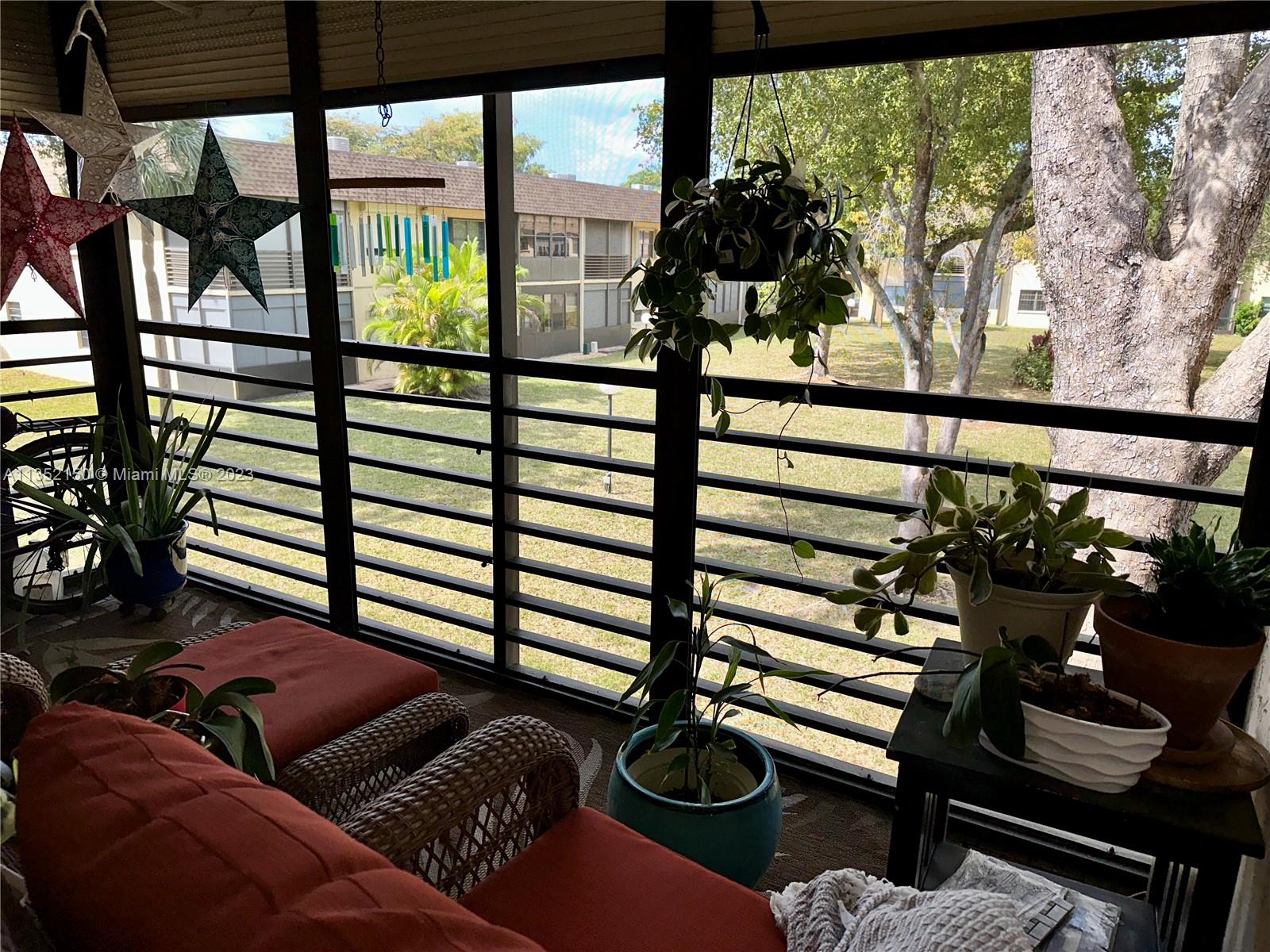 250 Gate Road, Unit 258 Hollywood, FL 33024 - Photo 17 of 30 a view of a living room and floor to ceiling window or tree