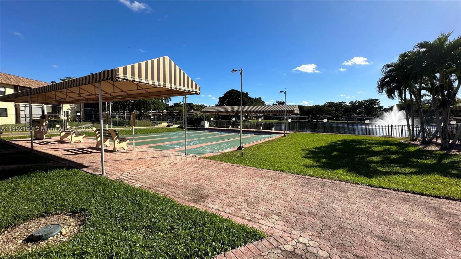 250 Gate Road, Unit 258 Hollywood, FL 33024 - Photo 19 of 30 a view of a house with a yard and sitting area