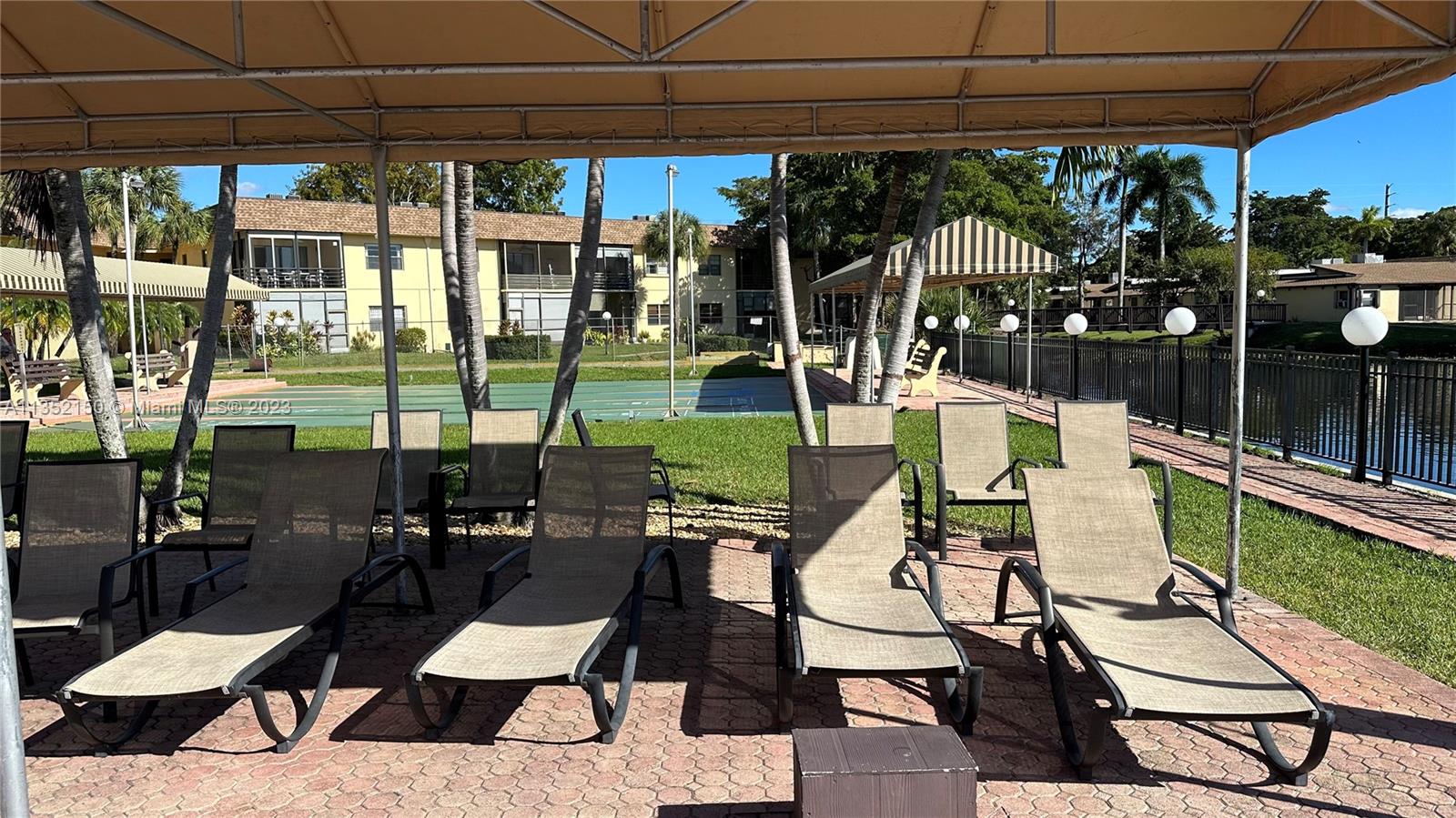 250 Gate Road, Unit 258 Hollywood, FL 33024 - Photo 25 of 30 a view of a patio with swimming pool