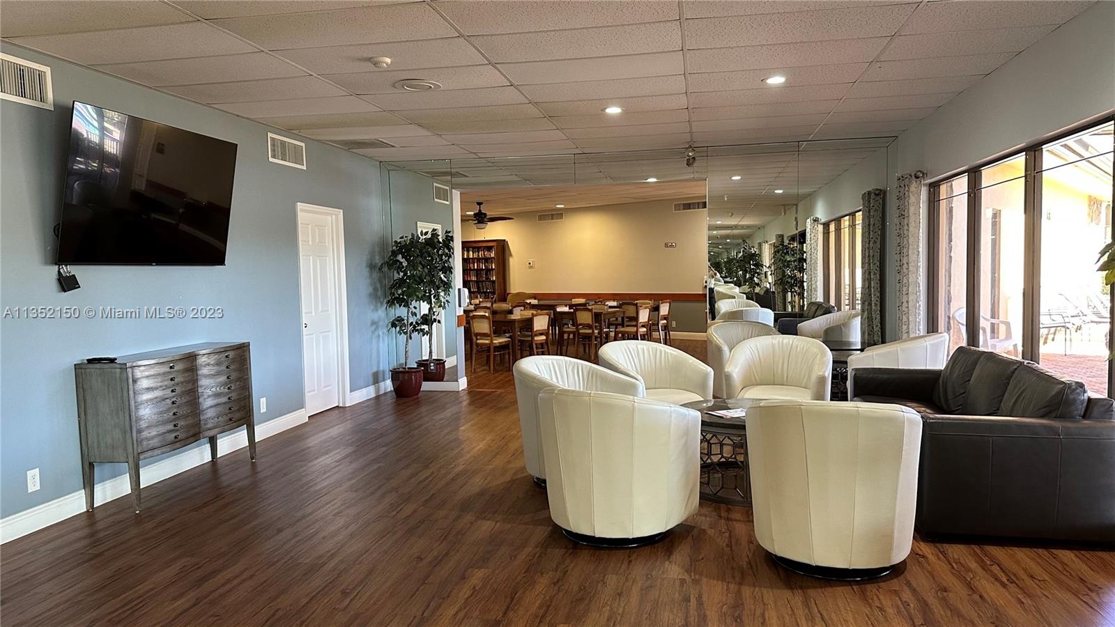 250 Gate Road, Unit 258 Hollywood, FL 33024 - Photo 27 of 30 a living room with furniture and a flat screen tv