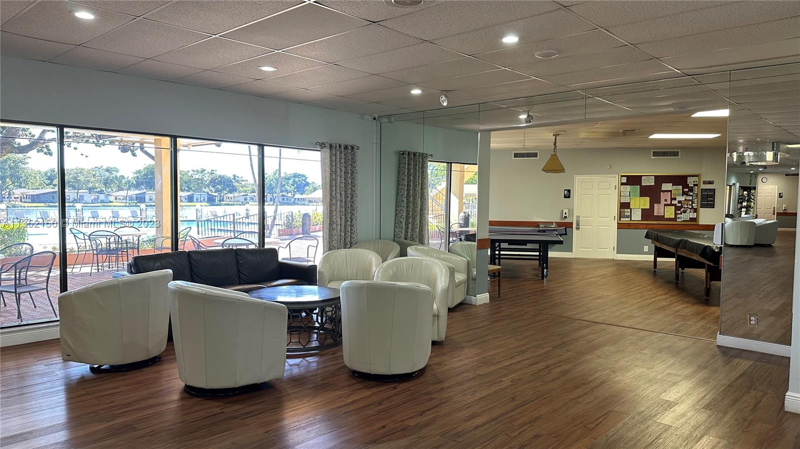 250 Gate Road, Unit 258 Hollywood, FL 33024 - Photo 28 of 30 a living room with furniture and large windows