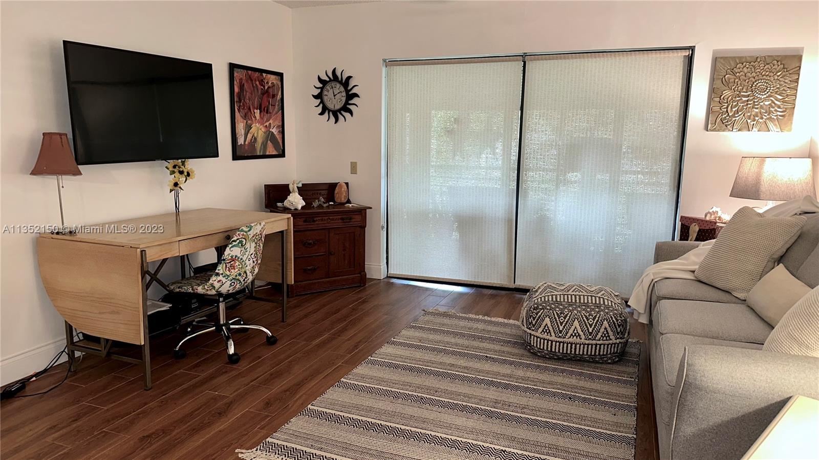 250 Gate Road, Unit 258 Hollywood, FL 33024 - Photo 3 of 30 a living room with furniture and a flat screen tv