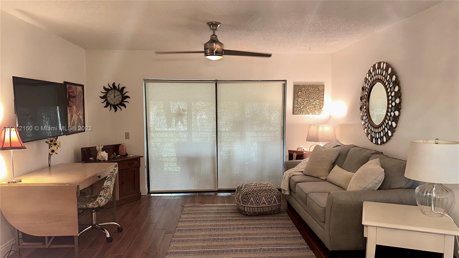 250 Gate Road, Unit 258 Hollywood, FL 33024 - Photo 4 of 30 a living room with furniture and a flat screen tv