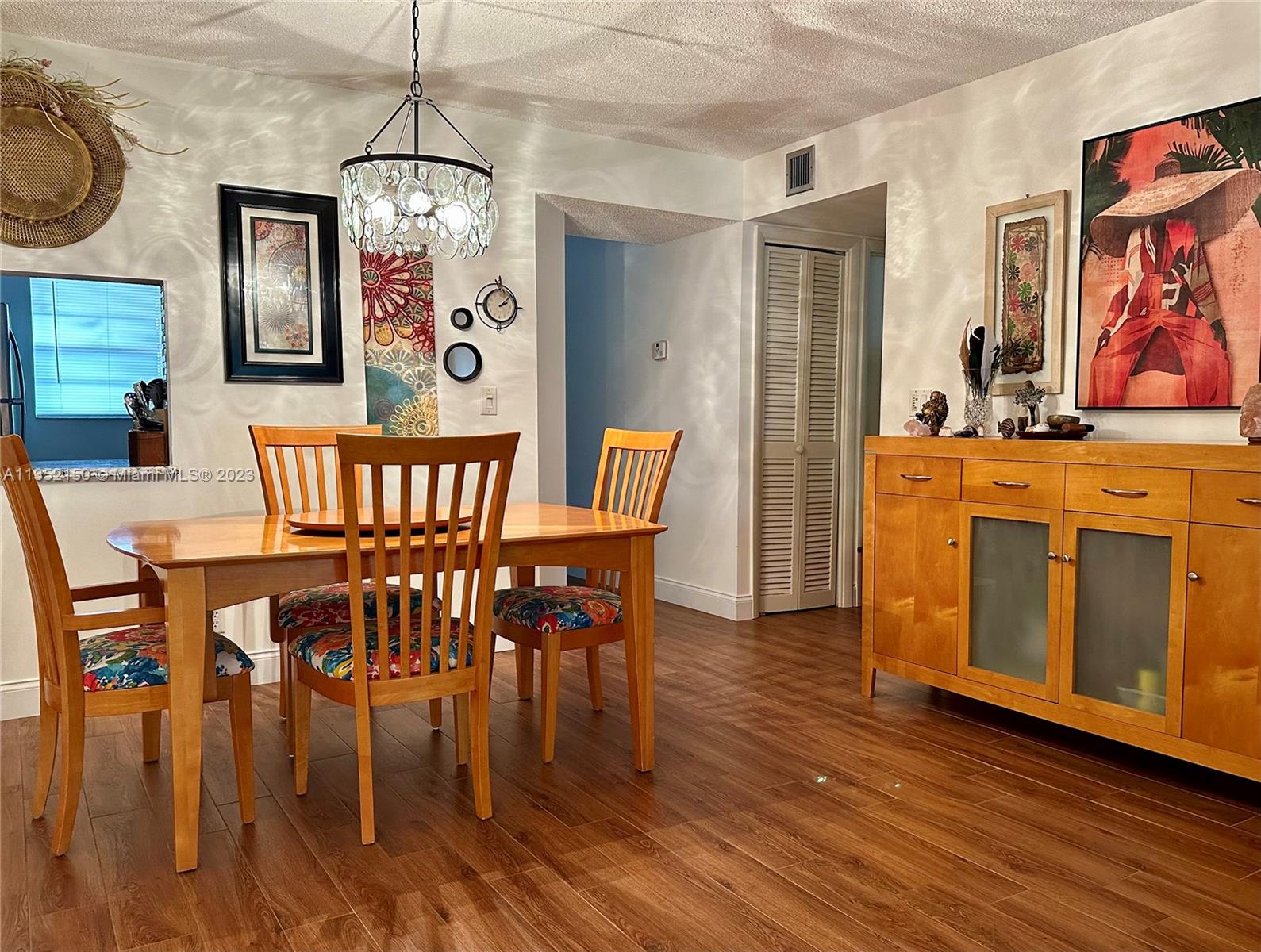 250 Gate Road, Unit 258 Hollywood, FL 33024 - Photo 6 of 30 a view of a dining room with furniture window and wooden floor