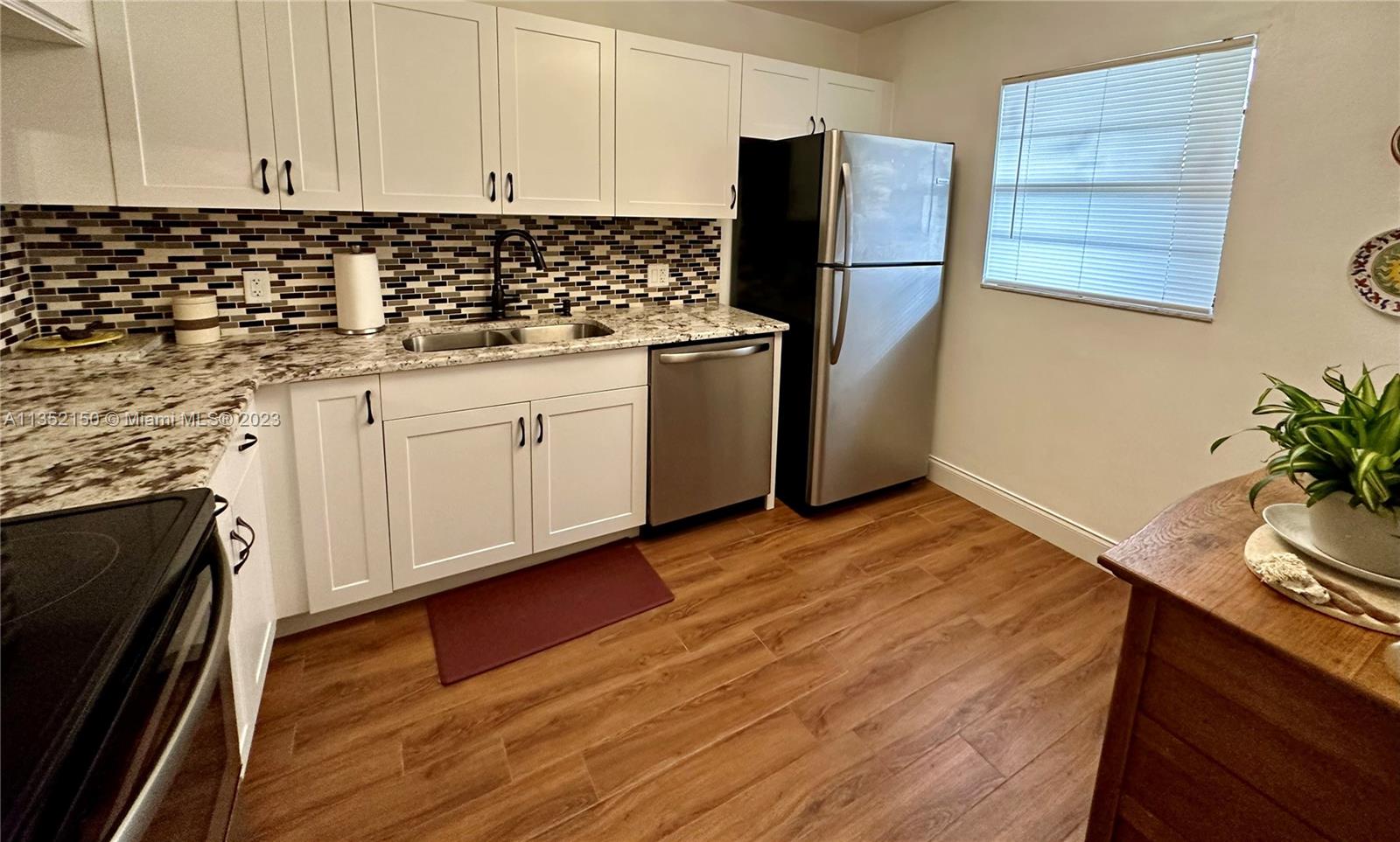 250 Gate Road, Unit 258 Hollywood, FL 33024 - Photo 10 of 30 a kitchen with granite countertop cabinets and steel stainless steel appliances