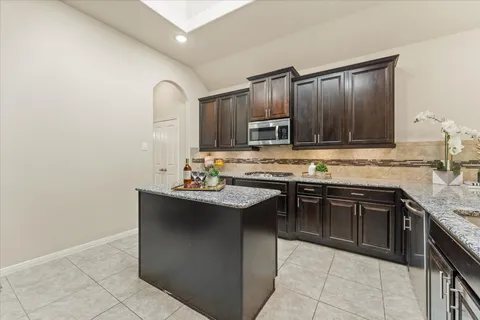 a view of kitchen with center island and windows