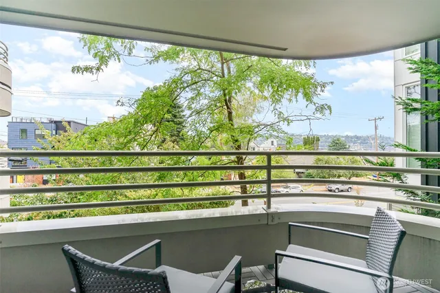 a kitchen with a table and chairs next to a large window