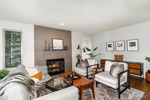 a living room with furniture fireplace and a window