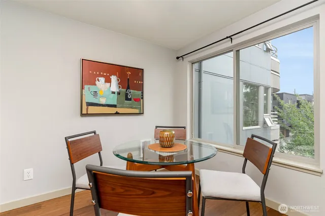 a dining room with furniture and wooden floor