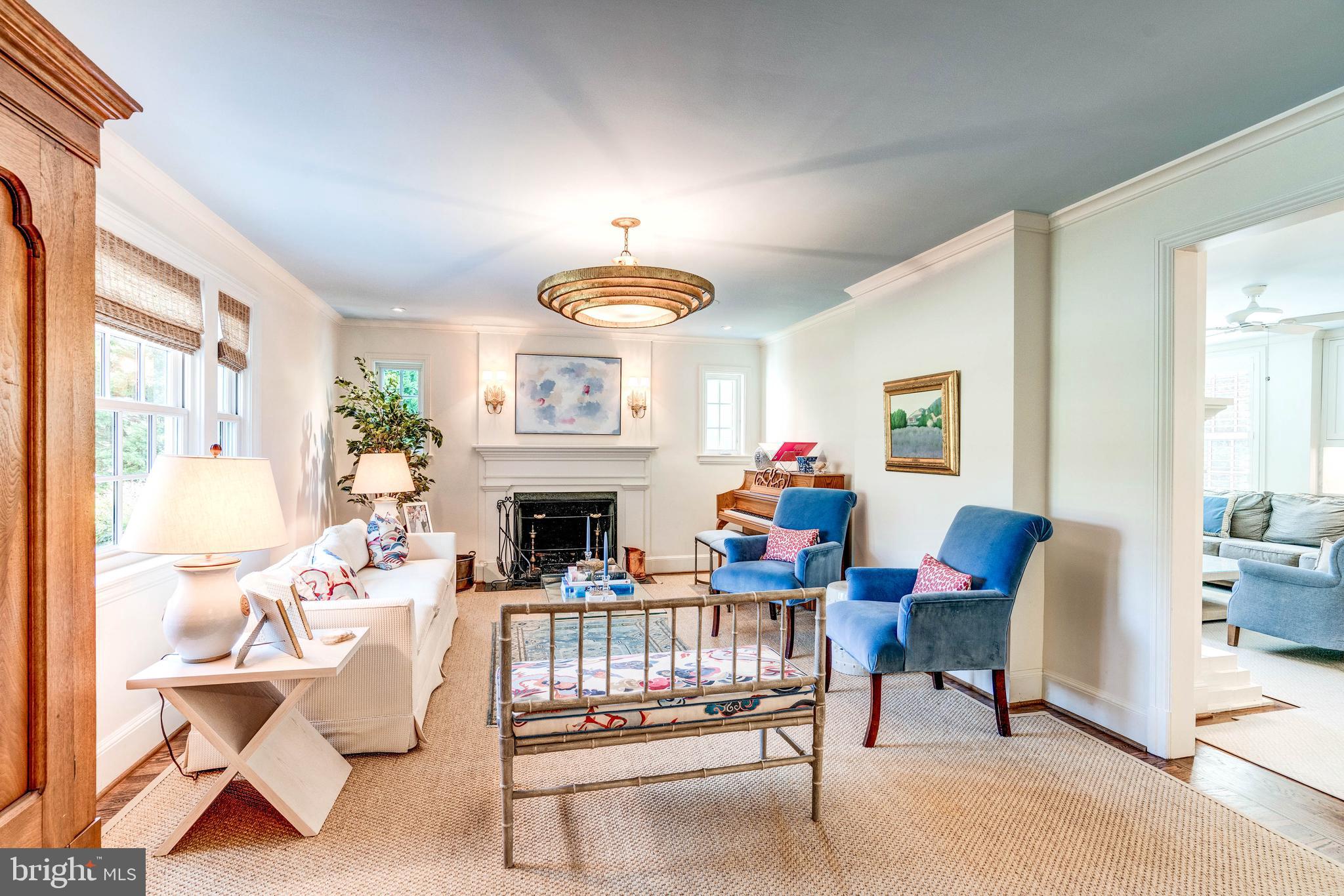 4509 Wetherill Road Bethesda, MD 20816 - Photo 11 of 89 a living room with furniture a fireplace and a large window