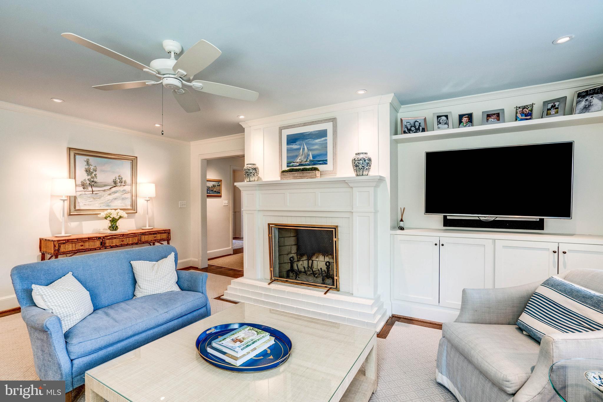 4509 Wetherill Road Bethesda, MD 20816 - Photo 22 of 89 a living room with furniture a flat screen tv and a fireplace