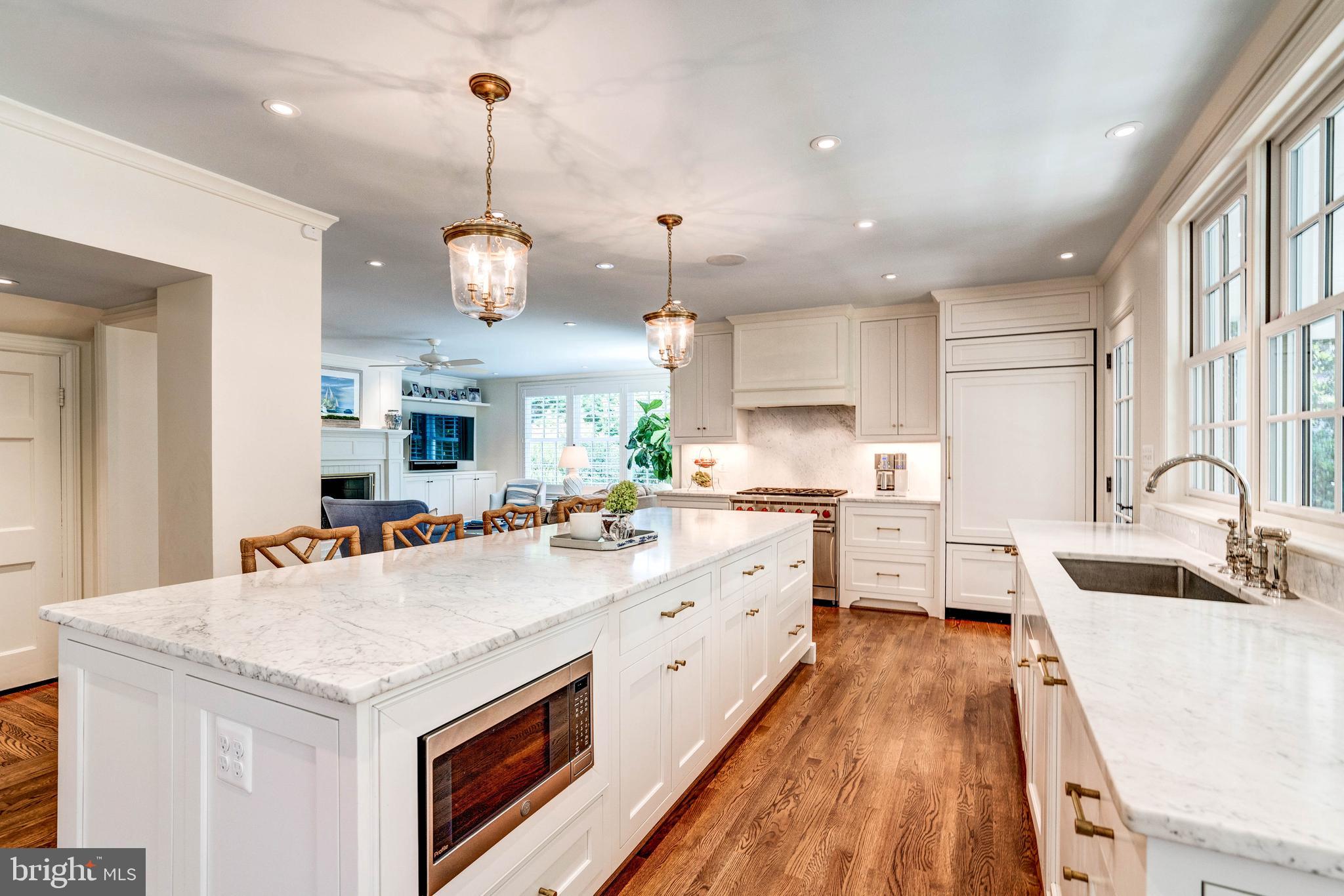 4509 Wetherill Road Bethesda, MD 20816 - Photo 29 of 89 a large kitchen with kitchen island a large counter space a sink appliances and cabinets