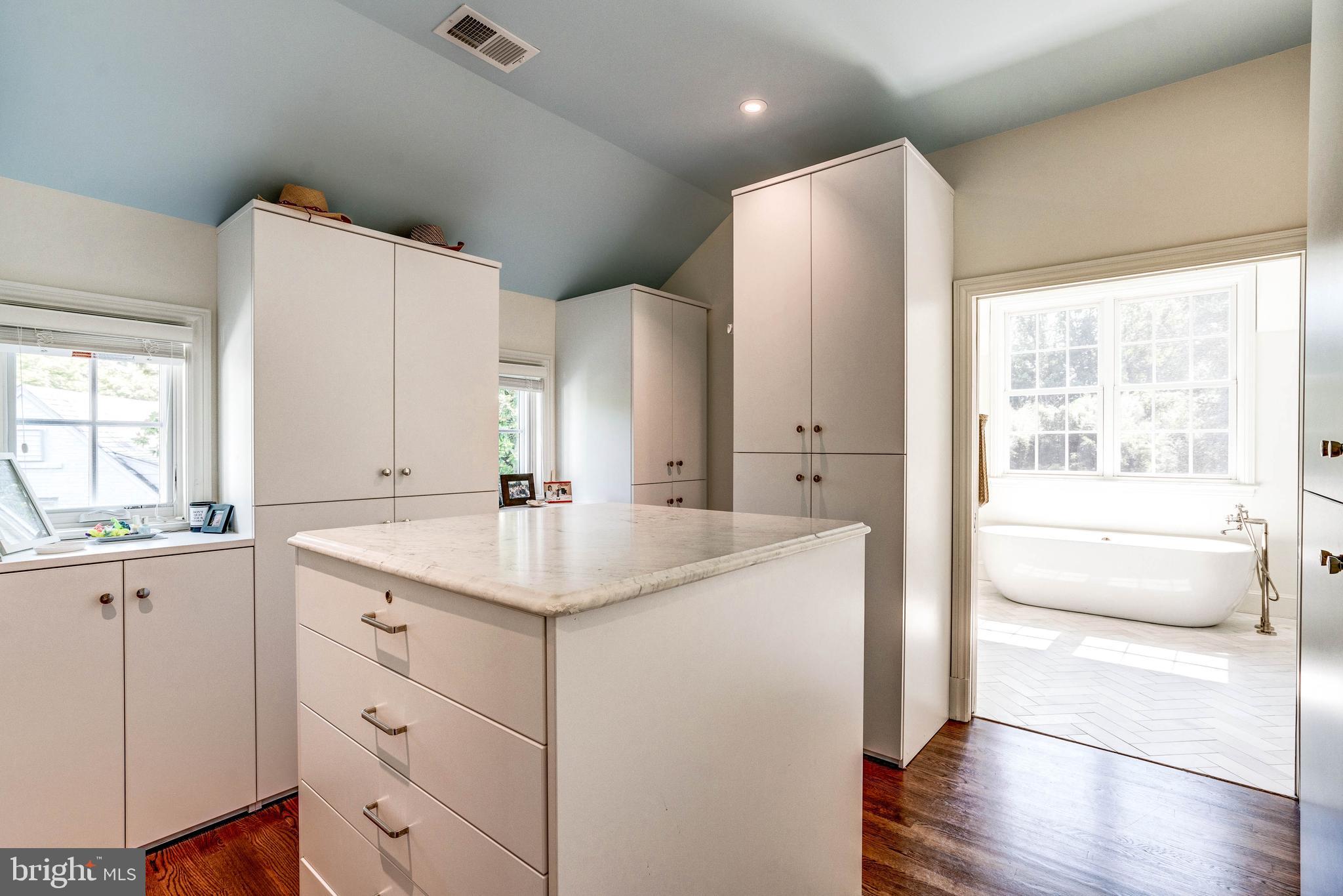 4509 Wetherill Road Bethesda, MD 20816 - Photo 45 of 89 a spacious bathroom with a granite countertop sink a toilet a large mirror and shower