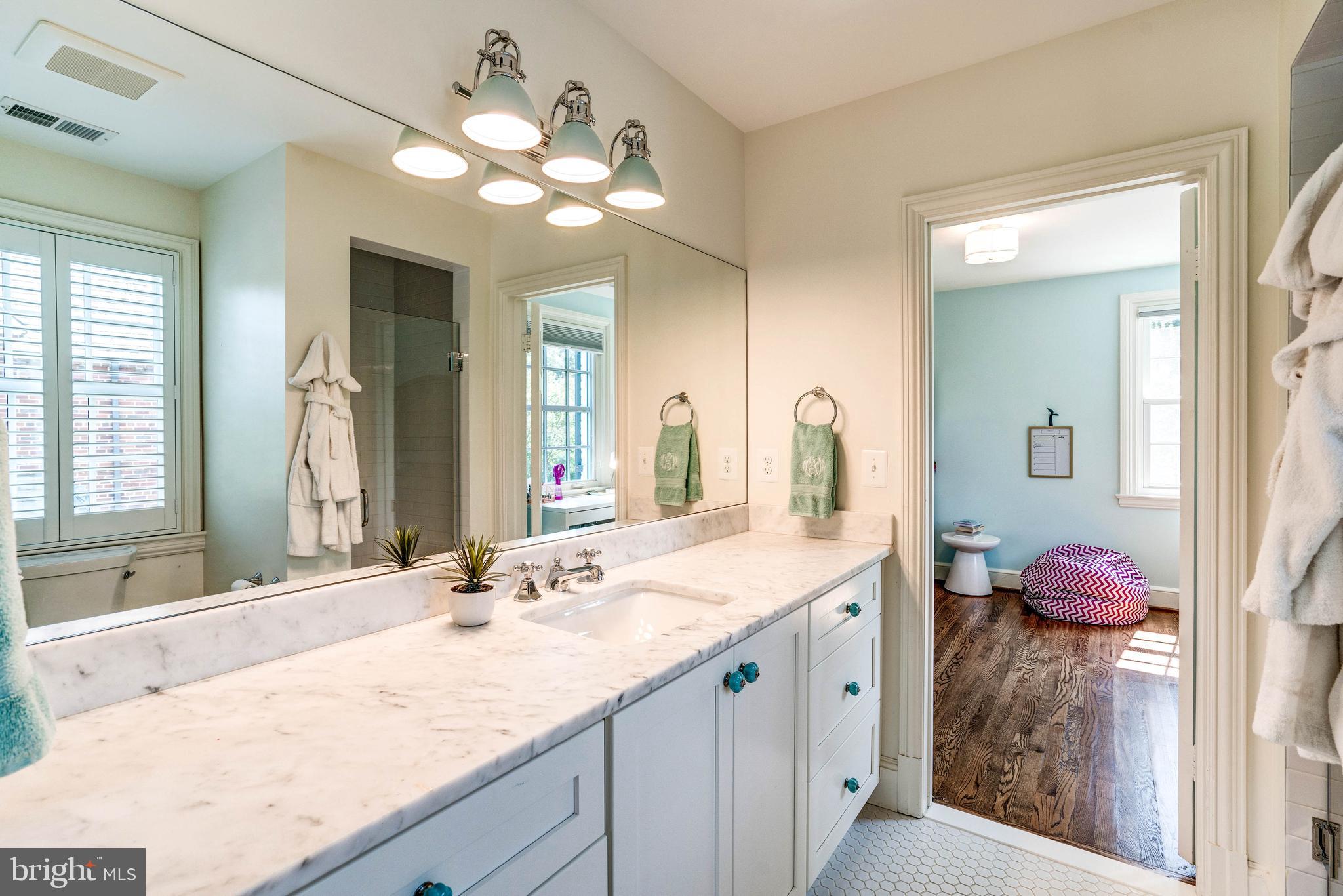 4509 Wetherill Road Bethesda, MD 20816 - Photo 61 of 89 a bathroom with a granite countertop sink and a mirror