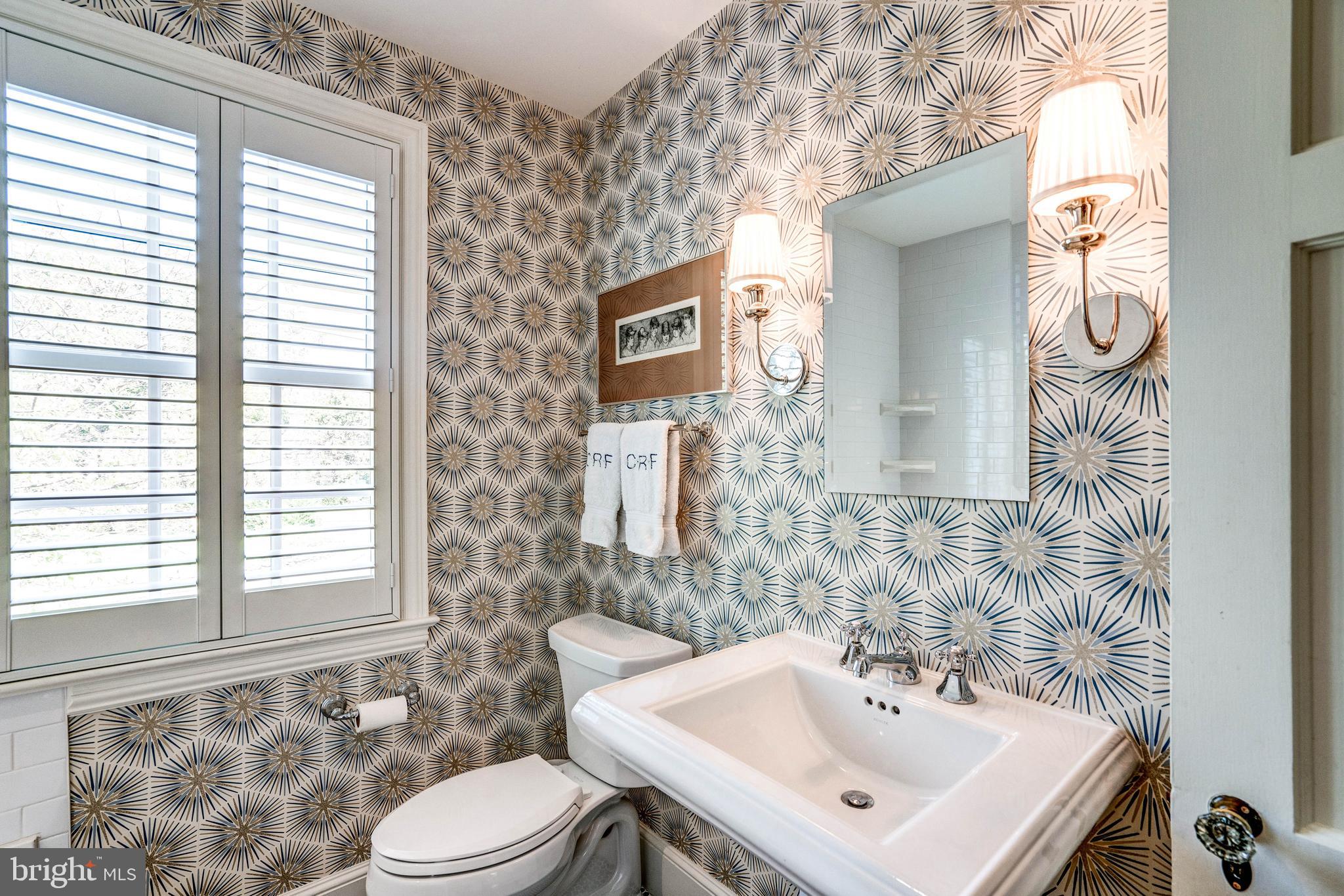 4509 Wetherill Road Bethesda, MD 20816 - Photo 66 of 89 a bathroom with a sink a toilet and a mirror