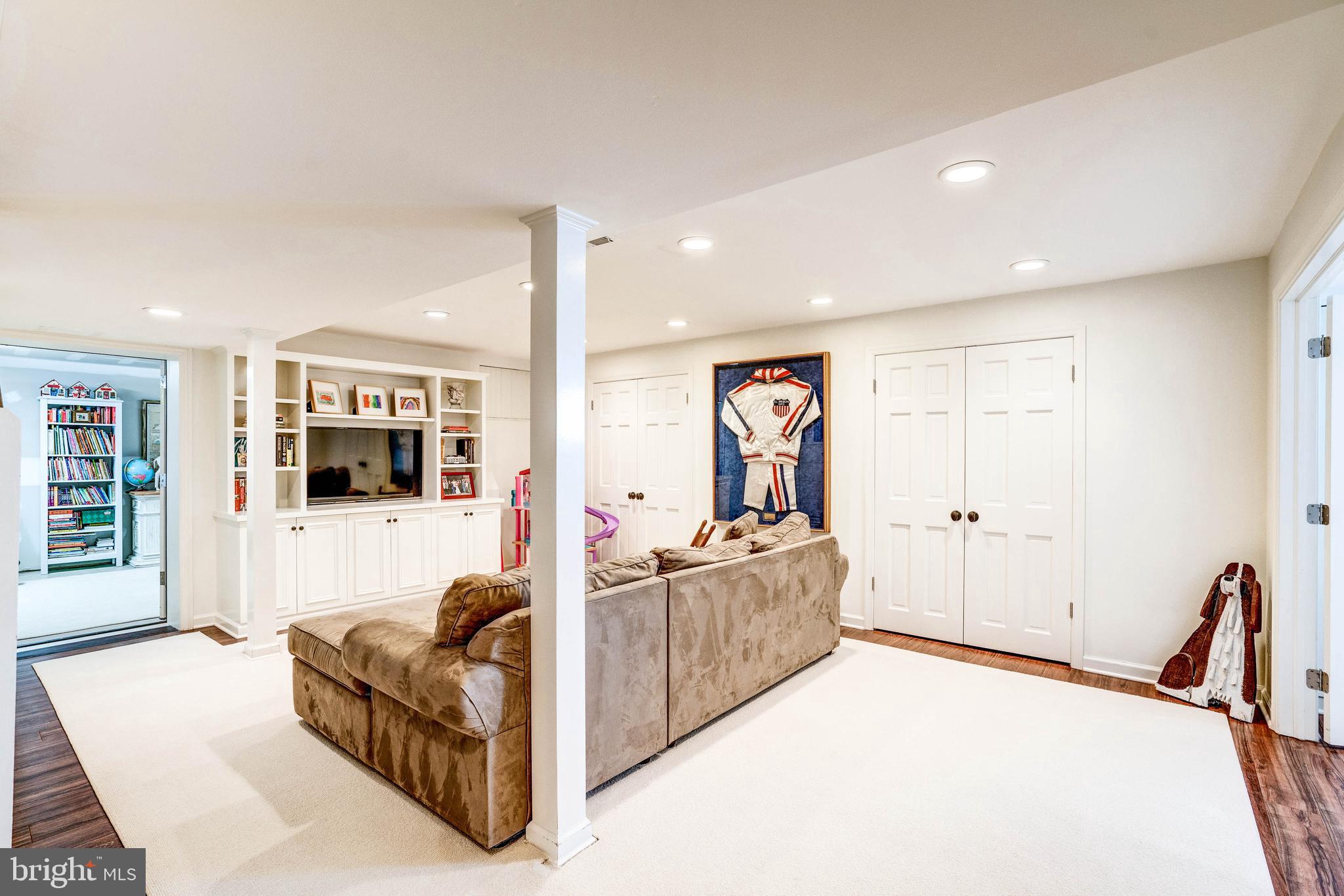 4509 Wetherill Road Bethesda, MD 20816 - Photo 67 of 89 a living room with furniture and a flat screen tv